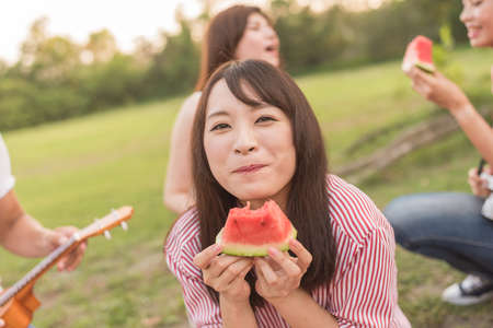 Asian people take a picnic with watermelonの写真素材