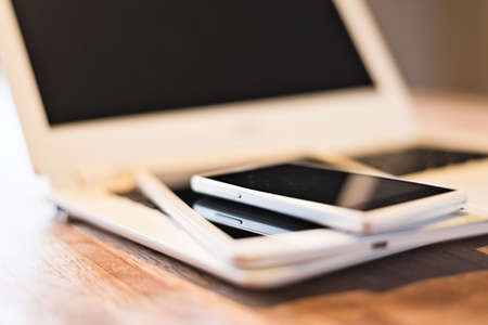phone and tablet on a laptop, closeup imageの写真素材