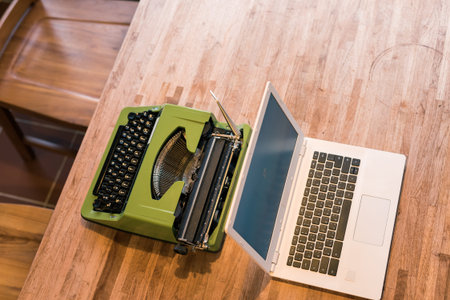 old typewriter and laptop on the table