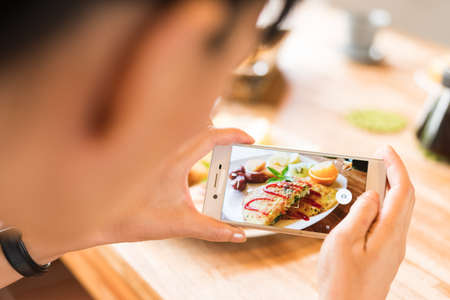 taking photo at morning breakfast on tableの写真素材