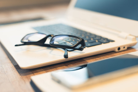 glasses and laptop on the table with nobody, concept of working at home