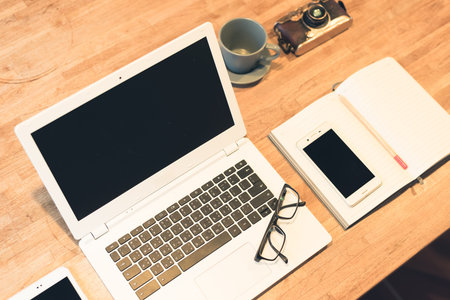 glasses and laptop on the table with nobody, concept of working at home