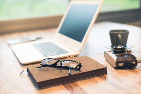 glasses and laptop on the table with nobody, concept of working at homeの写真素材