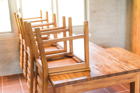 put wooden chairs on the desk and cleaning