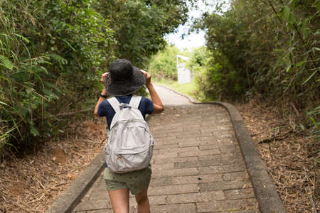 woman take a picture when hiking at outdoorの写真素材