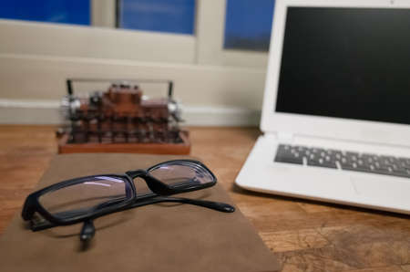 working at home with laptop on the wooden table in the nightの写真素材