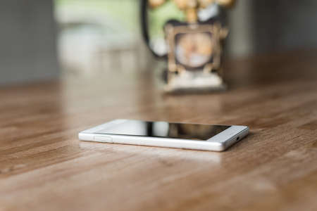 new and old telephone on the wooden deskの写真素材