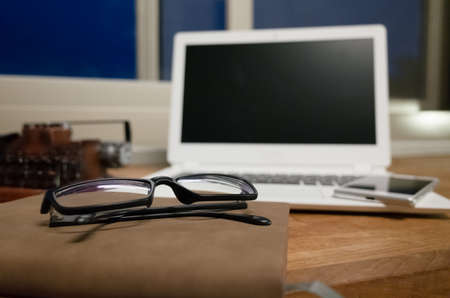 working at home with laptop on the wooden table in the nightの写真素材
