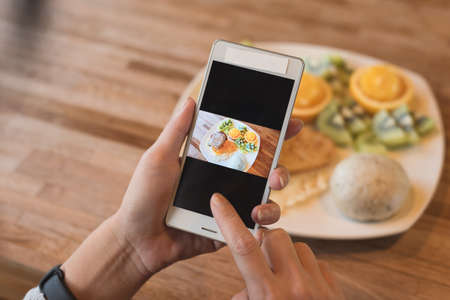 taking photo at breakfast on tableの写真素材