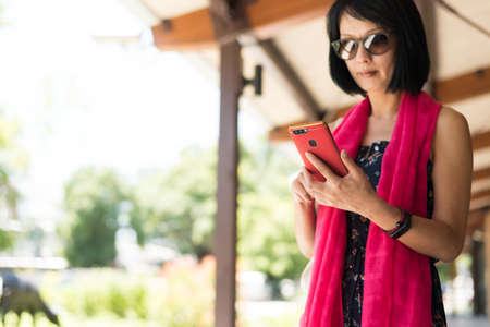 woman using cellphone at the corridor at the stationの写真素材