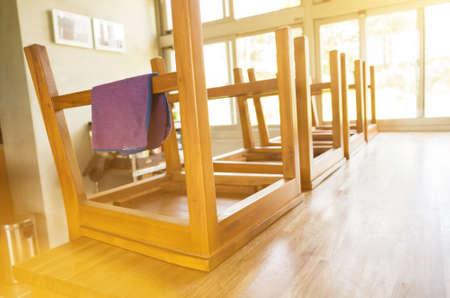 put wooden chairs on the desk and cleaningの写真素材