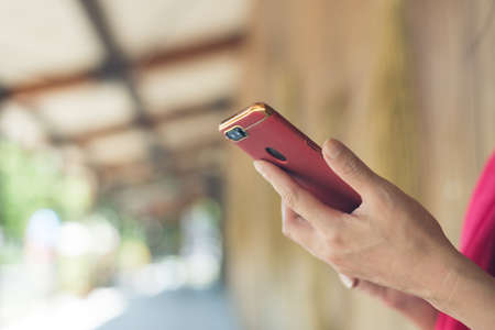 woman using a cellphone at the corridor at stationの写真素材