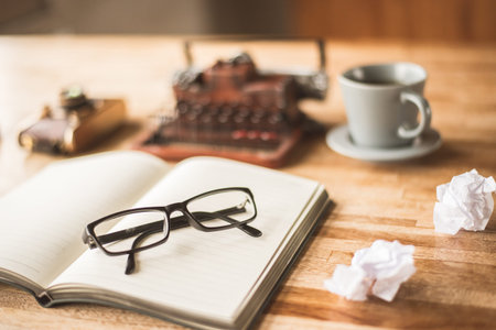 blank note book with typewriter on the desk at home