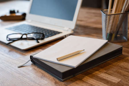 pencils and laptop on the table with nobodyの写真素材