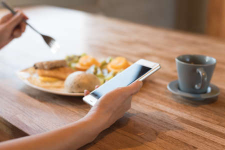 woman using smartphone, close-up image with handの写真素材