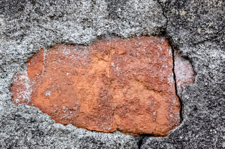 grunge gray wall background with crack and bricks