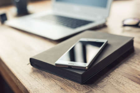 smart phone on the table with nobody, concept of working at homeの写真素材