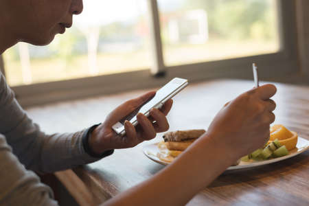 woman using smartphone, close-up image with handの写真素材