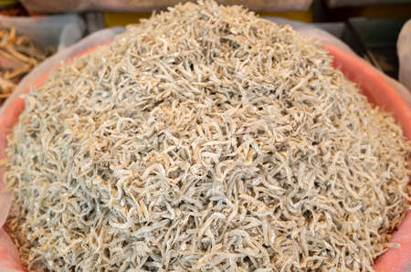 heap of dried anchovies fish at the traditional marketの写真素材
