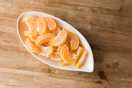 oranges at the dish on the tableの写真素材