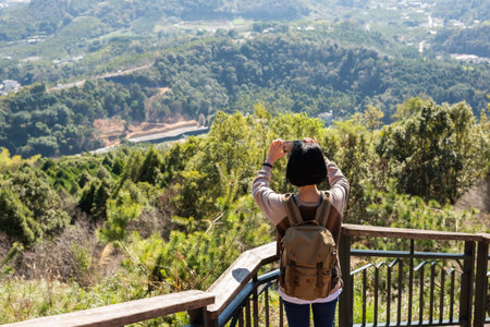 rear view of woman take a picture in the outdoor