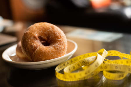 donuts with tailor measuring tape, concept of healthyの写真素材