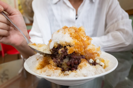 woman eat famous Taiwan snacks of shave iceの写真素材
