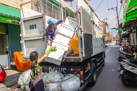 Nantou, Taiwan - March 19th, 2019: white recycling truck for collects recyclable materials in the...