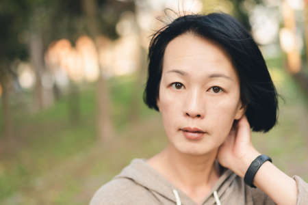 portrait of mature Asian beautiful woman at parkの写真素材