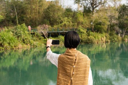 traveling woman take a picture near Sun Moon Lake, Nantou, Taiwan