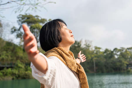 peaceful traveling Asian mature woman feel free stand near Sun Moon Lake, Nantou, Taiwanの写真素材