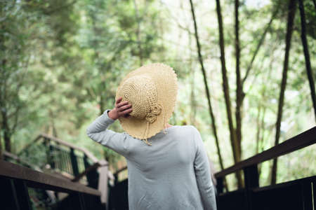 Asian woman walking at the stairs in the outdoor forestの写真素材
