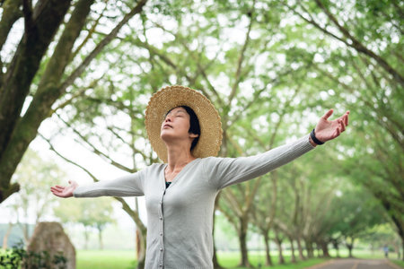 Asian mature beauty open arms and feel free under the trees