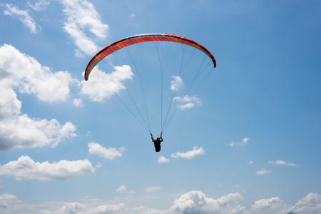 colorful paragliding under blue sky in the townの写真素材