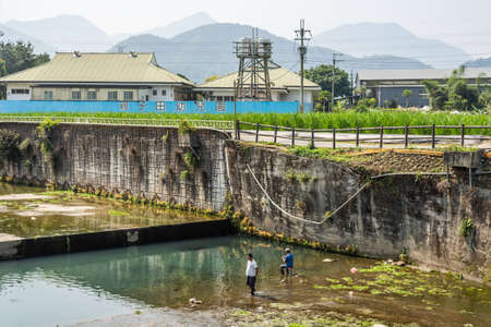 Nantou, Taiwan - April 7th, 2019:people fishing at a dirty ditch at Puli township, Nantou, Taiwan, Asiaのeditorial素材