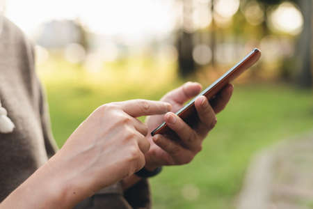 woman using smartphone, concept of social media and technology in the outdoorの写真素材