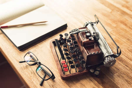 notebook with typewriter on the table with nobody, concept of working at homeの写真素材