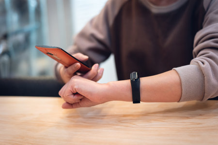 woman using smart watch and cellphone in the restaurant