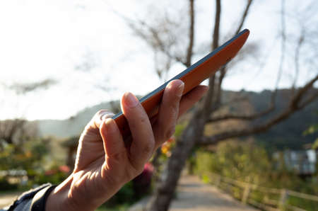 woman using smartphone, concept of social media and technology in the outdoorの写真素材