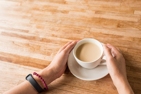 woman hold a cup a coffee at home
