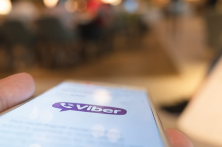 Taipei, Taiwan - May 12th, 2019:using social media at a smartphone in a restaurant in Taipei,...