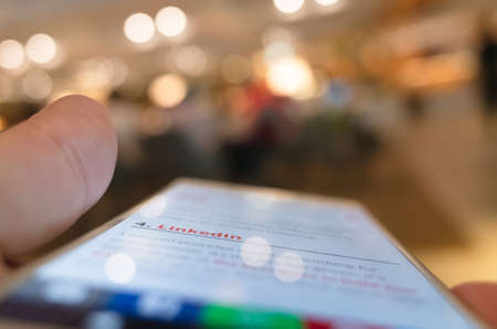 Taipei, Taiwan - May 12th, 2019:using social media at a smartphone in a restaurant in Taipei, Taiwan, Asiaのeditorial素材