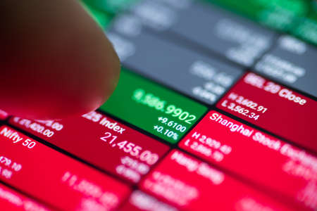 macro view of man using stock market application on touchscreen smartphone, shallow depth of focusのeditorial素材