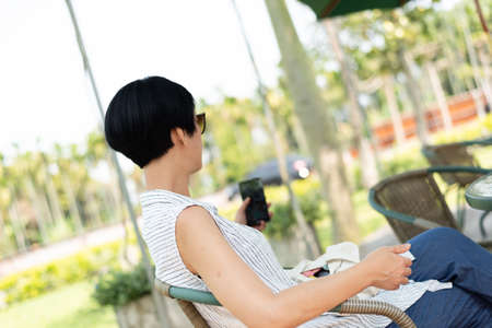 woman sit and take a selfie in the outdoorの写真素材