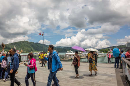 Nantou, Taiwan - May 30th, 2019: tourists and boats at Xuanguang temple pier in Sun Moon Lake, Nantou, Taiwanのeditorial素材