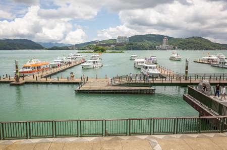 Nantou, Taiwan - May 30th, 2019: tourists and boats at Xuanguang temple pier in Sun Moon Lake, Nantou, Taiwanのeditorial素材