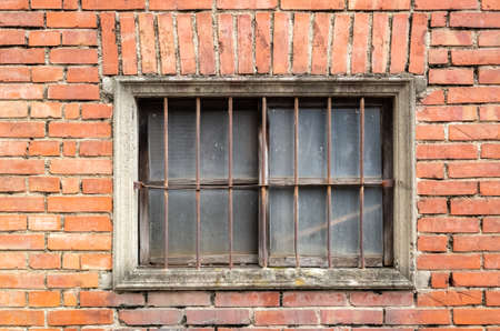 old window on red brick wall in the outdoorの写真素材