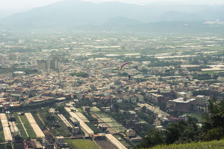 colorful paragliding over blue sky with white clouds in the town, Puli, Taiwanの写真素材