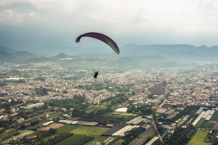 colorful paragliding over blue sky with white clouds in the town, Puli, Taiwan