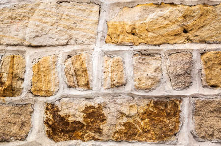 aged yellow brick wall with good textureの写真素材